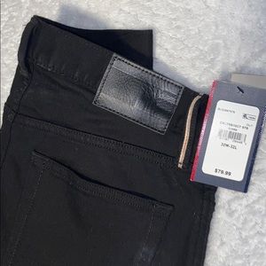 All blacked out Tommy Hilfiger denim jeans.